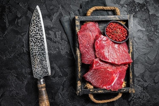 Uncooked wild venison game meat, illustrating "what is game meat?".