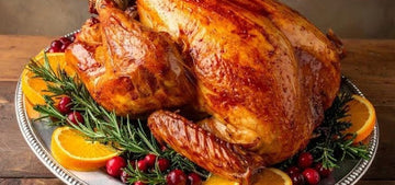 Golden oven-roasted whole bird with crispy skin in a roasting pan, showing how to cook a whole chicken perfectly at home.